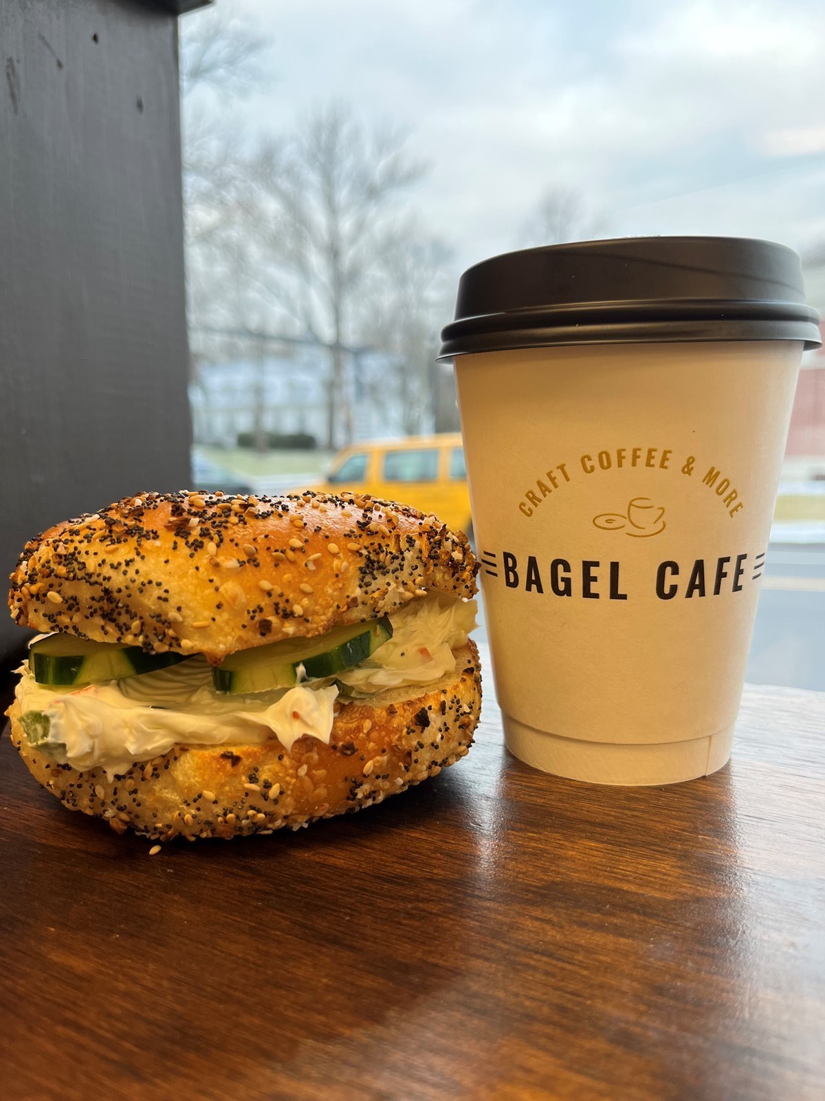 Coffee and a bagel sandwich